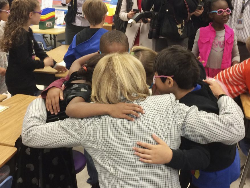 Education Secretary Betsy DeVos hugs students at Ashland Elementary School in Manassas, Va., Tuesday, April 25, 2017, where many children’s parents serve in the military, during a visit of the school in recognition of the Month of the Military Child. (AP Photo/Maria Danilova)