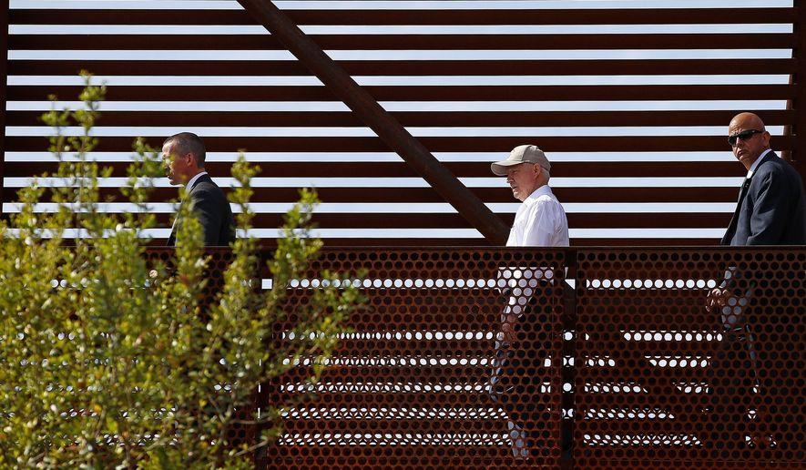 FILE - In this April 11, 2017, file photo, Attorney General Jeff Sessions, center, tours the U.S.-Mexico border with border officials in Nogales, Ariz. A courthouse on the border in Texas is serving as a model for the kind of tough immigration enforcement advocated by President Donald Trump. “This is a new era. This is the Trump era,” Sessions said during a visit to the border in Nogales, Ariz., this month. (AP Photo/Ross D. Franklin)