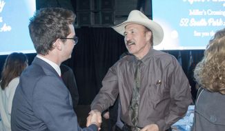 FILE - In this March 18, 2017 file photo, Congressional candidate Rob Quist meets with supporters during the annual Mansfield Metcalf Celebration dinner hosted by the state&#x27;s Democratic Party in Helena, Montana. He is trying to fire up the party faithful in his race against Republican Greg Gianforte in a May 25 special election to fill Montana&#x27;s sole congressional seat. (AP Photo/Bobby Caina Calvan, File)
