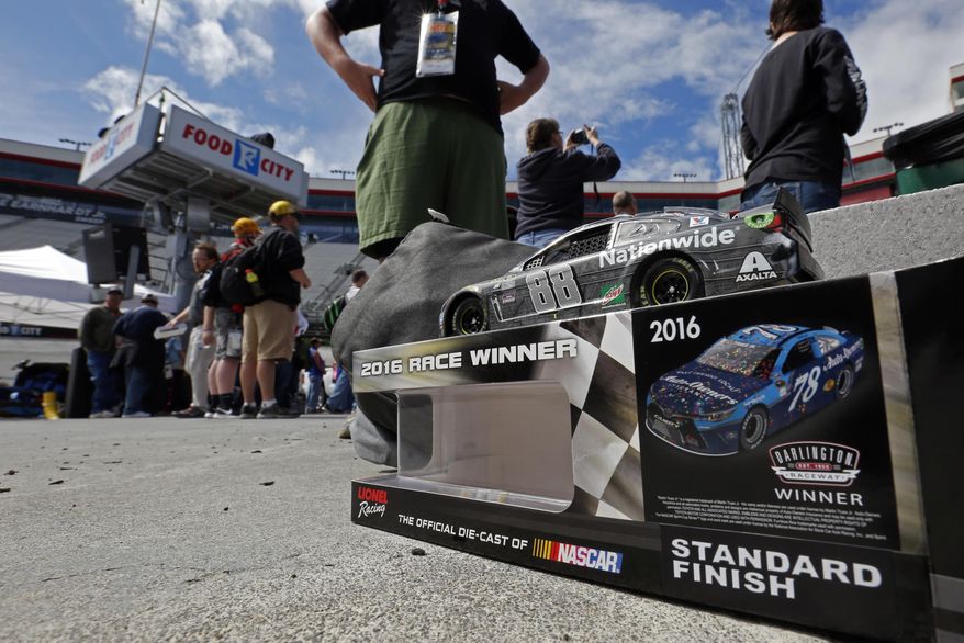 A model car of driver Dale Earnhardt Jr. waits to be autographed before a NASCAR Monster Energy NASCAR Cup Series auto race, Monday, April 24, 2017 in Bristol, Tenn. (AP Photo/Wade Payne)