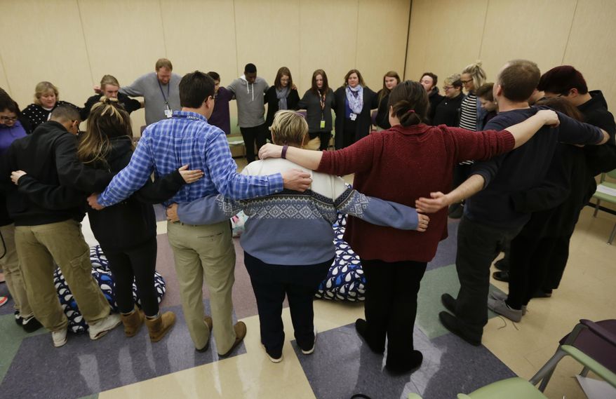 In this Monday, March 13, 2017 photo, students and teachers gather for an all-school meeting called "circle" at Hope Academy in Indianapolis. For teenagers in treatment for addiction, returning to school means resisting offers to get high with old friends. Researchers say these kids do better at special “recovery schools” that use peer pressure in a different way, to support sobriety. Hope Academy in Indianapolis is one of about three dozen recovery schools in the United States. (AP Photo/Michael Conroy)