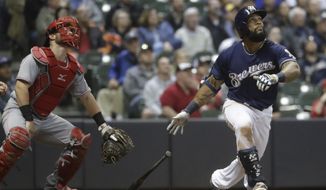 Milwaukee Brewers&#39; Eric Thames hits a two-run home run during the sixth inning of a baseball game against the Cincinnati Reds Tuesday, April 25, 2017, in Milwaukee. (AP Photo/Morry Gash)
