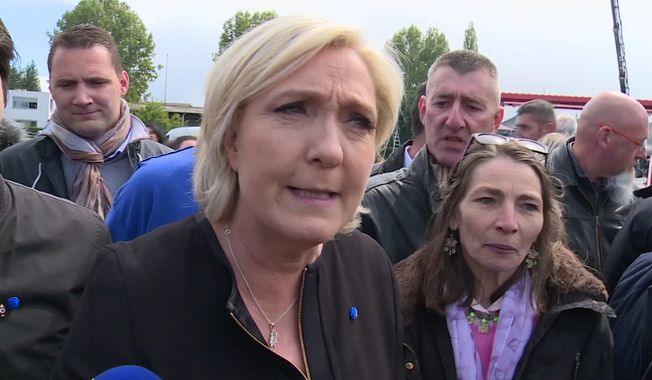 Far-right French presidential candidate Marine Le Pen is greeted by workers outside a whirlpool home appliance factory in Amiens, France, Wednesday April 26, 2017.   While her centrist presidential opponent Macron was meeting with union leaders from the Whirlpool plant in northern France, Le Pen popped up outside the factory itself, amid its workers and declared herself the candidate of France&#x27;s workers.(AP Photo)