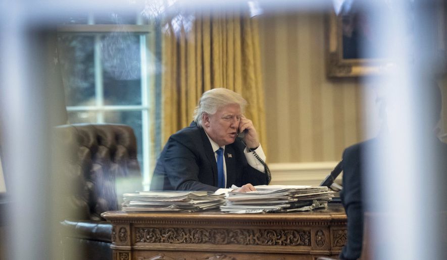 DAY 9 - In this Jan. 28, 2017, file photo, President Donald Trump speaks on the phone with German Chancellor Angela Merkel in the Oval Office at the White House in Washington. (AP Photo/Andrew Harnik, File)