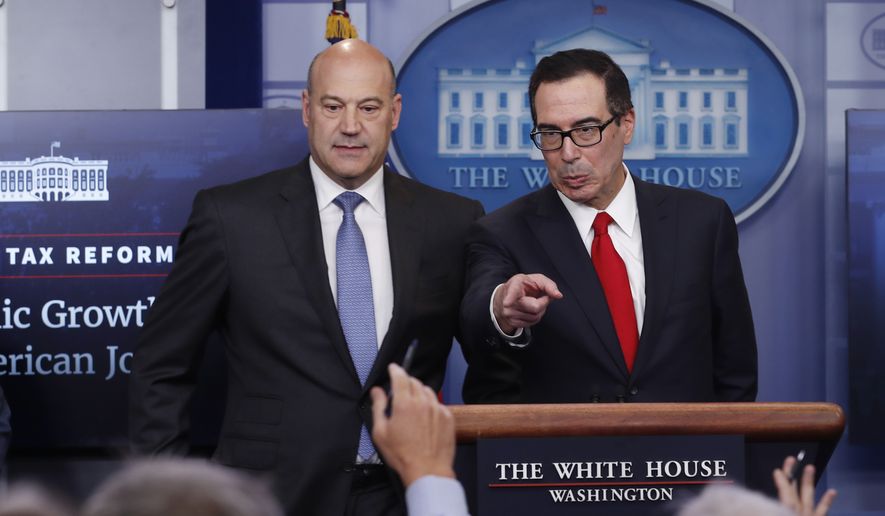 Treasury Secretary Steven Mnuchin, right, joined by National Economic Director Gary Cohn, speaks in the briefing room of the White House, in Washington, Wednesday, April 26, 2017. President Donald Trump is proposing dramatically reducing the taxes paid by corporations big and small in an overhaul his administration says will spur economic growth and bring jobs and prosperity to the middle class. (AP Photo/Carolyn Kaster)