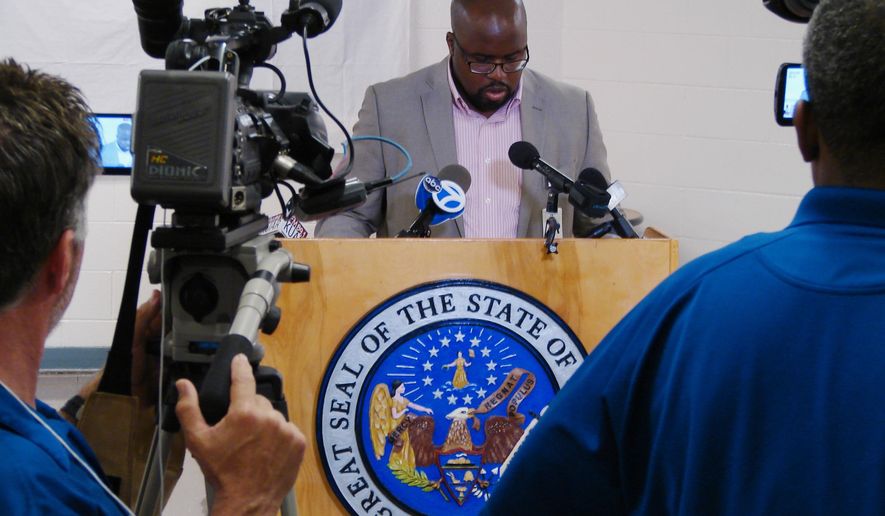 In this Monday, April 24, 2017, photo, Solomon Graves, a spokesman for the Arkansas Department of Correction, speaks to reporters at the Cummins Unit prison in Varner, Ark. Graves' agency relies on reporters and citizen witnesses to verify that the state has conducted an execution. A fourth execution this month is set for Thursday. (AP Photo/Kelly P. Kissel)