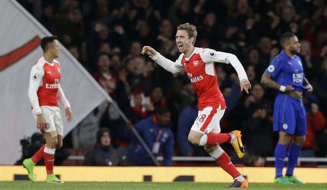 Arsenal&#x27;s Nacho Monreal celebrates after scoring the opening goal of the game during the English Premier League soccer match between Arsenal and Leicester City at the Emirates Stadium in London, Wednesday, April 26, 2017. (AP Photo/Alastair Grant)