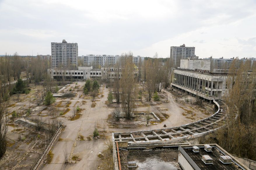 This photo taken Wednesday, April 5, 2017, shows a central square in the deserted town of Pripyat, some 3 kilometers (1.86 miles) from the Chernobyl nuclear power plant Ukraine. Once home to some 50,000 people whose lives were connected to the Chernobyl nuclear power plant, Pripyat was hastily evacuated one day after a reactor at the plant 3 kilometers (2 miles away) exploded on April 26, 1986. The explosion and the subsequent fire spewed a radioactive plume over much of northern Europe. (AP Photo/Efrem Lukatsky)