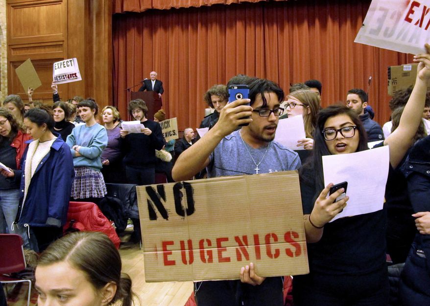 FILE - In this March 2, 2017, file photo, Middlebury College students turn their backs to author Charles Murray during his lecture in Middlebury, Vt. After a series of protests around the country, some institutions are rethinking their security and tactics in an age of growing political polarization. (AP Photo/Lisa Rathke, File)