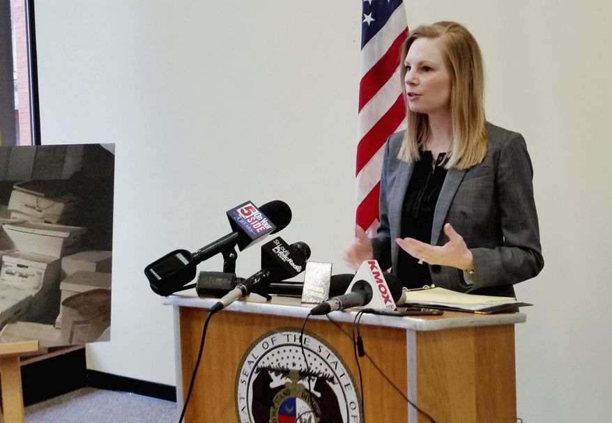 Missouri Auditor Nicole Galloway stands next to a photo of mold-damaged files from the Ferguson municipal court during a news conference Wednesday, April 26, 2017, in St. Louis, where she discussed an audit that gave a poor rating to the court. The audit launched in the wake of unrest following the 2014 fatal police shooting of Michael Brown in Ferguson, Mo. found the city's court system "in disarray" and disorganized, according to Galloway. (AP Photo/Jim Salter)