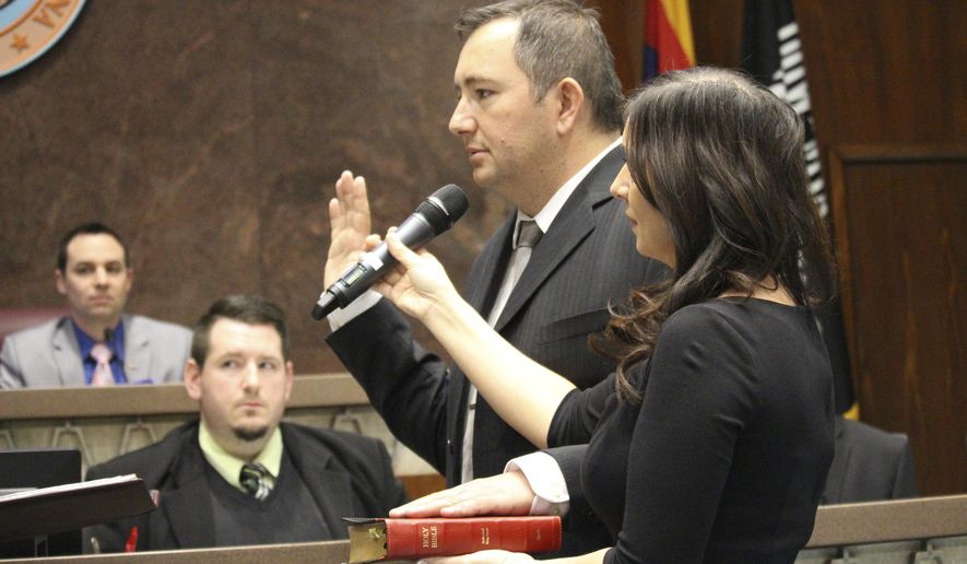 Peoria real estate broker and former city councilman, Ben Toma is sworn in as a member of the Arizona House of Representatives in Phoenix, Ariz., on Wednesday, April 26, 2017. His wife, Ana Toma, right, holds the Bible. Toma was picked from three nominees by the county Board of Supervisors to replace Republican Rep. Phil Lovas, who resigned to take a job with the Trump Administration. (AP Photo/Bob Christie)