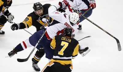 FILE - In this March 20, 2016, file photo, Pittsburgh Penguins&#39; Kris Letang (58) checks Washington Capitals&#39; Alex Ovechkin (8) off the puck during the first period of an NHL hockey game in Pittsburgh. The Capitals and Penguins are almost unchanged from their playoff meeting a year ago, but the small differences could make a major impact in their second-round series. Pittsburgh doesn’t have defenseman Kris Letang, while Washington has added depth in center Lars Eller and defenseman Kevin Shattenkirk that makes it think it can topple the defending Stanley Cup champions. (AP Photo/Gene J. Puskar, File)