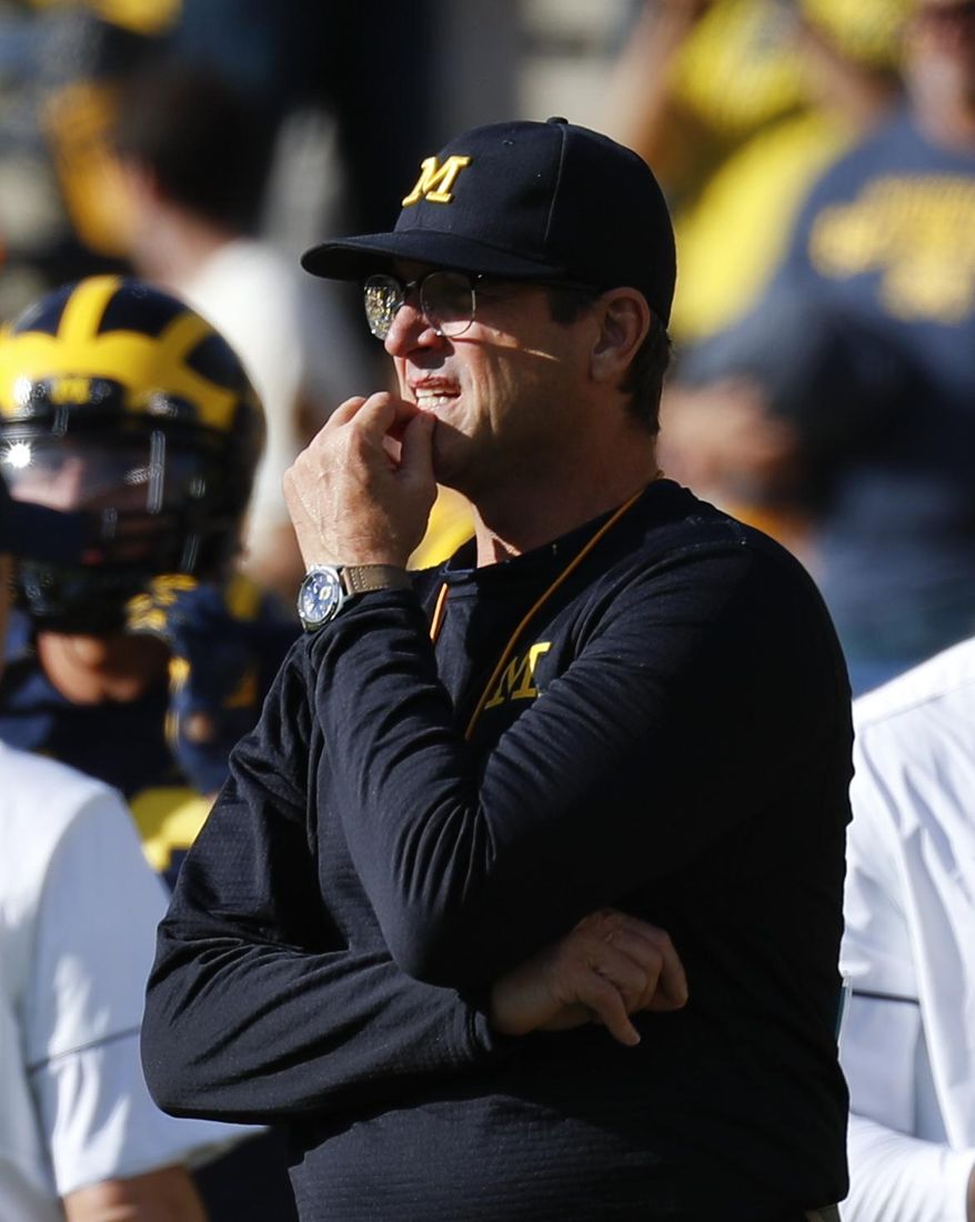 University of Michigan coach Jim Harbaugh watches players get ready for an NCAA college football game against Maryland in Ann Arbor, Michigan, Nov. 5, 2016. (AP Photo/Paul Sancya) ** FILE **