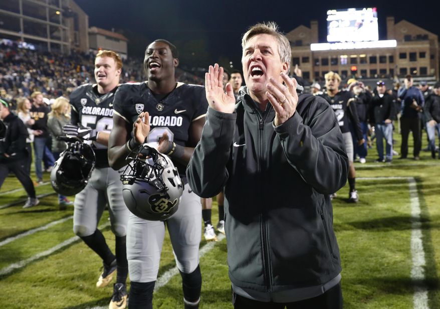 FILE - In this Nov. 19, 2016, file photo, Colorado coach Mike MacIntyre sings the school song with players after the team's 38-24 win over Washington State in an NCAA college football game in Boulder, Colo. The Buffaloes were one of 2016's best turnaround teams, winning the Pac-12 South after years of floundering. Mike MacIntyre won AP coach of the year for righting a ship that had long been listing. A major part of the turnaround was a much improved defense. Not only does CU have to replace eight defensive starters, including several NFL-caliber players, but coordinator Jim Leavitt left for Oregon, too. (AP Photo/David Zalubowski, File)