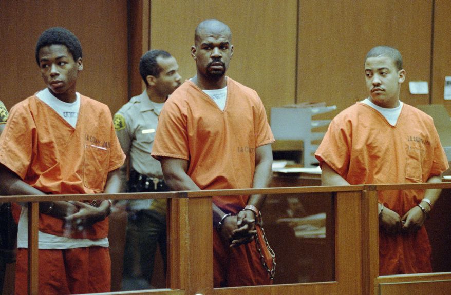 FILE - In this Aug. 25, 1992 file photo, from left, Antoine Miller, Henry Watson and Damian Williams stand in Superior Court in Los Angeles for arraignment on charges in connection with the riot-related beating of trucker Reginald Denny. The case was assigned to a black judge who was immediately removed by the prosecution, raising defense claims of racism. (AP Photo/Nick Ut)