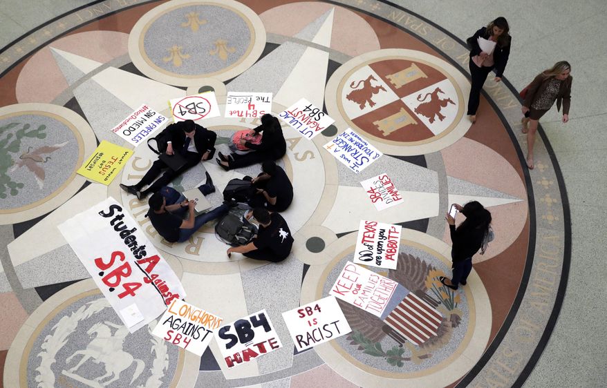 Students gather in the Rotunda at the Texas Capitol to oppose SB4, an anti-"sanctuary cities" bill that already cleared the Texas Senate and seeks to jail sheriffs and other officials who refuse to help enforce federal immigration law, as the Texas House prepares to debate the bill, Wednesday, April 26, 2017, in Austin, Texas. (AP Photo/Eric Gay)