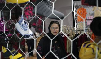 FILE- In this May 12, 2014 file photo, Jiddah United sports club founder Lina Almaeena stands in her sporting goods shop in Jiddah, Saudi Arabia. A proposal to establish physical education colleges in Saudi female has failed to win enough votes in the kingdom&#39;s Shura Council, which advises government. (AP Photo/Hasan Jamali, File)