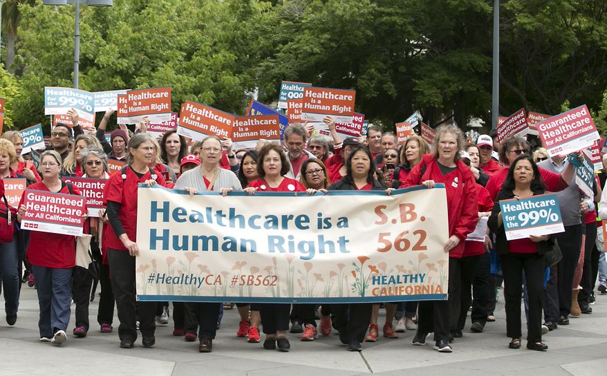 Supporters of single-payer health care march to the Capitol Wednesday, April 26, 2017, in Sacramento, Calif. The bill, SB562 by Democratic State Senators Ricardo Lara, of Bell Gardens, and Toni Atkins, of San Diego, that would guarantee health coverage with no out-of-pocket cost for all California residents, including people living in the country illegally is to be heard in the Senate Health Committee, Wednesday. (AP Photo/Rich Pedroncelli)