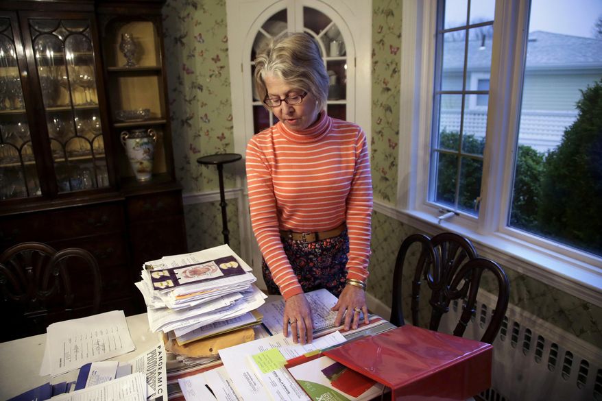 ADVANCE FOR RELEASE AT 12:01 A.M. SUNDAY, MAY 7, 2017 AND THEREAFTER - In this Wednesday, April 19, 2017 photo Lisa Connor stands over paperwork generated by keeping special education services on track for her daughter at Connor's home in the Jamaica Plain neighborhood of Boston. Thousands of parents each year clash with their children's school districts over the level of special education services, including Connor. Connor's daughter has been diagnosed with a complex mix of disabilities that include epilepsy and a diagnosis on the autism spectrum. (AP Photo/Steven Senne)