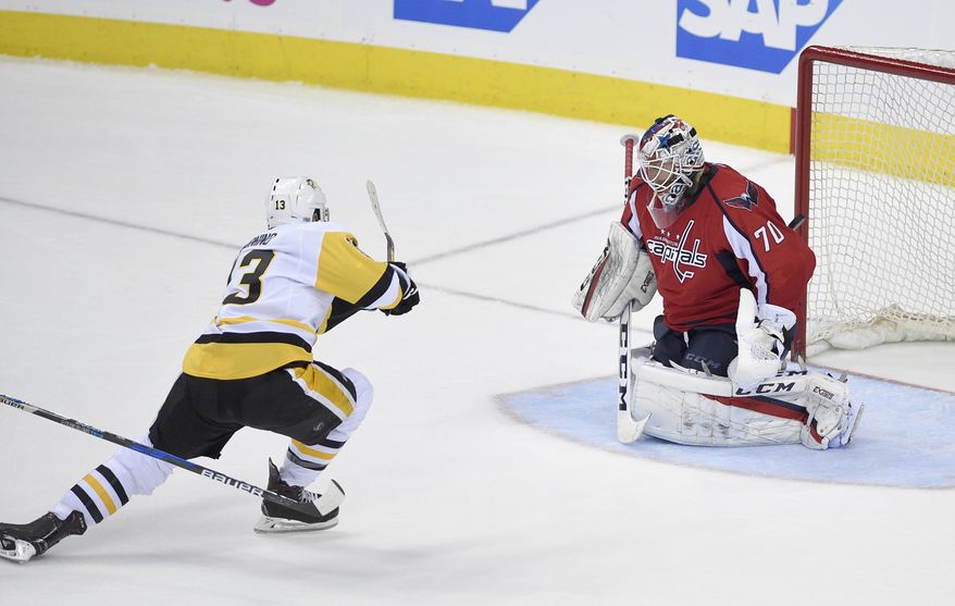 Pittsburgh Penguins center Nick Bonino (13) shoots the puck for a goal against Washington Capitals goalie Braden Holtby during the third period of Game 1 in an NHL hockey Stanley Cup second-round playoff series, Thursday, April 27, 2017, in Washington. The Penguins won 3-2. (AP Photo/Nick Wass)