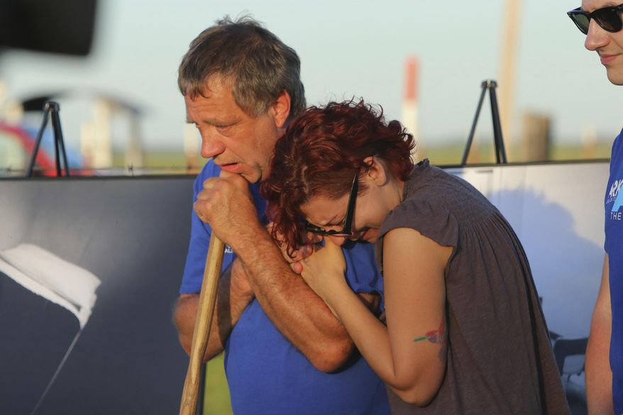 In this Monday, April 24, 2017 photo, Anti-death penalty supporter Randy Gardner, left, embraces Gina Grimm, daughter of inmate Jack Jones, outside the Varner Unit near Varner, Ark. Jack Jones and Marcel Williams received lethal injections on the same gurney Monday night, just about three hours apart. It was the first double execution in the United States since 2000. (Stephen B. Thornton/The Arkansas Democrat-Gazette via AP)