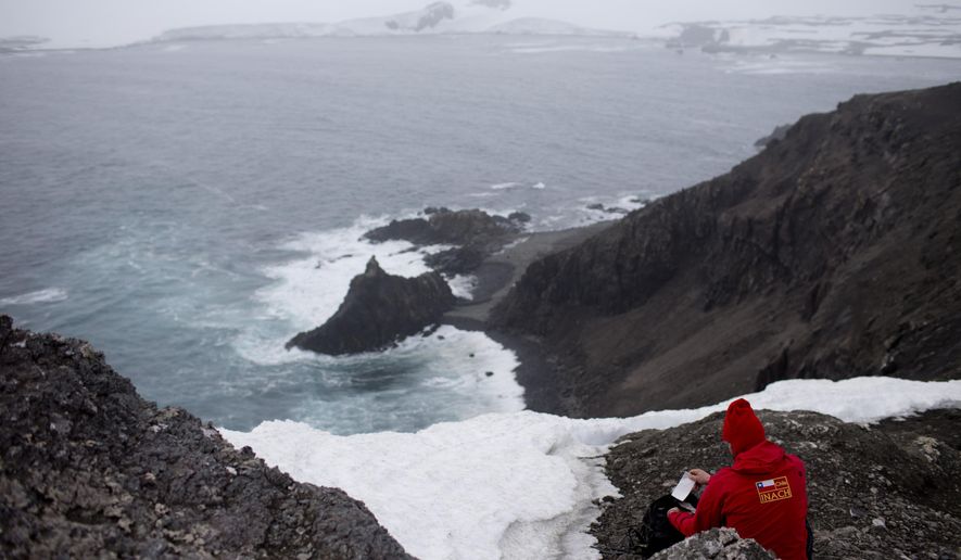 FILE - In this Jan. 24 2015, file photo, German scientist Andreas Beck takes notes in Robert Island, in the South Shetland Islands archipelago, Antarctica. Antarctica holds 90 percent of the world’s ice. California Ocean Protection Council deputy director Jenn Eckerle said ice melt in Antarctica raises sea levels more off California than it does for the world overall. (AP Photo/Natacha Pisarenko, File)