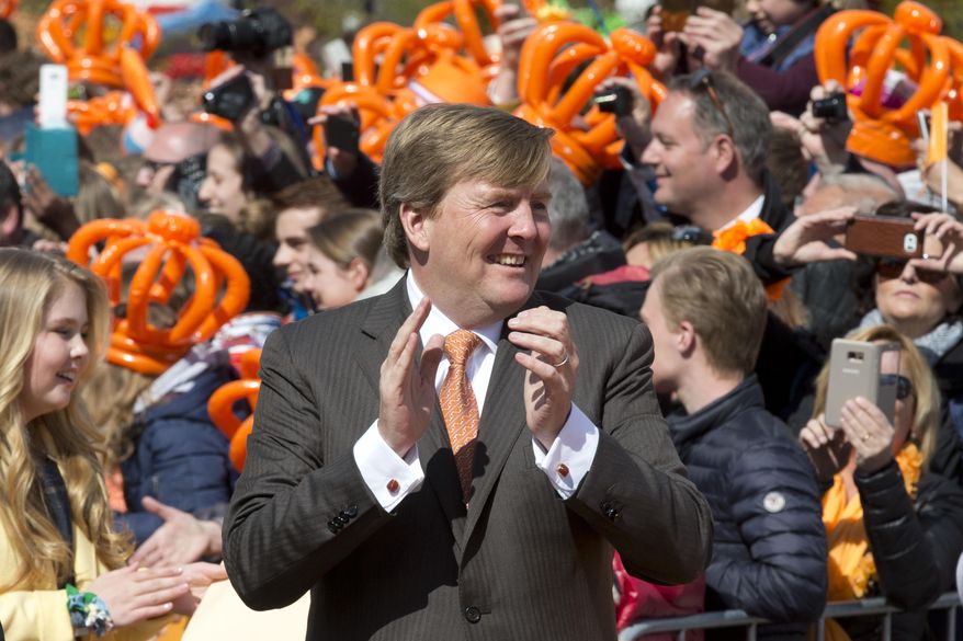 Dutch King Willem-Alexander dances to the music of a band as he celebrates his 50th anniversary on Kingsday in Tilburg, south central Netherlands, Thursday, April 27, 2017. (AP Photo/Peter Dejong)