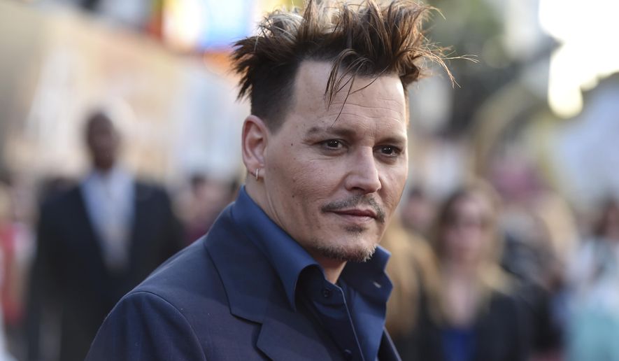 FILE - In this May 23, 2016, file photo, Johnny Depp arrives at the premiere of "Alice Through the Looking Glass" at the El Capitan Theatre in Los Angeles. Some visitors to the Pirates of the Caribbean ride at California’s Disneyland got a surprise Wednesday, April 26, 2017, when Depp appeared as Captain Jack Sparrow inside the ride. (Photo by Jordan Strauss/Invision/AP, File)