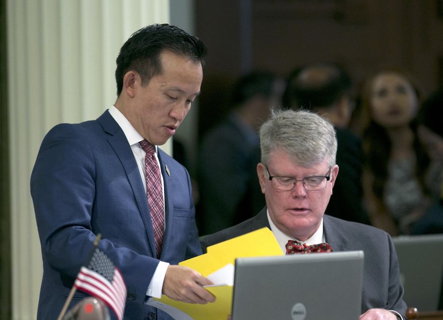 Assemblyman David Chu, D-San Francisco, left, talks with Assemblyman Mark Stone, D-Scotts Valley, after the Assembly unanimously passed Chiu's rape kit bill Thursday, April 27, 2017, in Sacramento, Calif. If approved by the Senate and signed by the governor, Chiu's measure, AB41, would require police departments to track the status of rape kits in an effort to reduce the backlog of untested evidence.(AP Photo/Rich Pedroncelli)