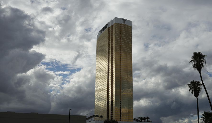In this Sept. 21, 2016, photo, the Trump International hotel is seen in Las Vegas. Fire officials say a suspect is in custody after two separate blazes were discovered at the hotel Wednesday, April 26, 2017, in Las Vegas. The Clark County Fire Department released a statement saying toasters, towels and various other materials were used to ignite the fires at the hotel bearing President Donald Trump's name. (AP Photo/John Locher)
