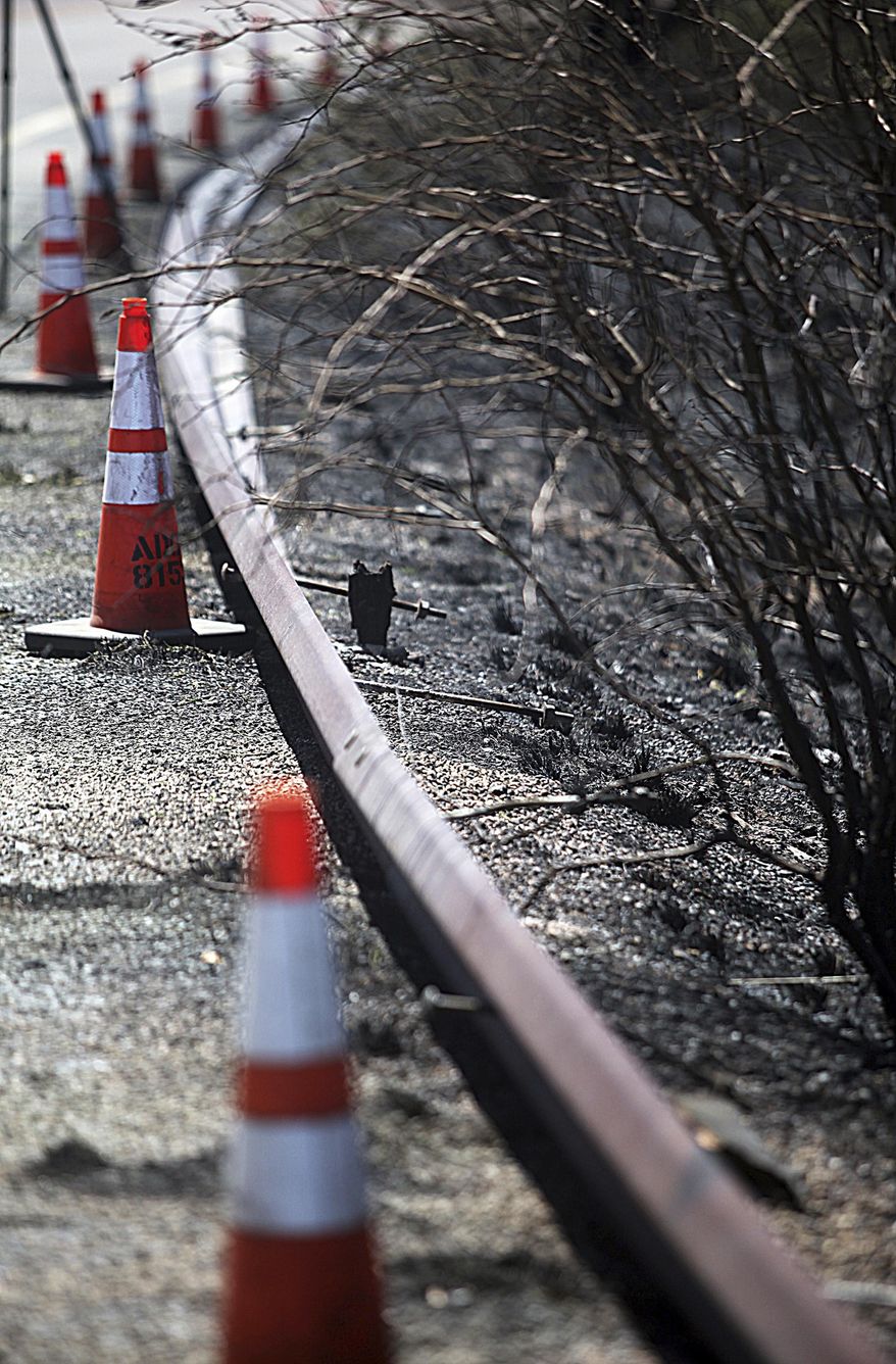 Damaged guard railing along Highway 83 due to a wildfire can be seen along the route in Sonoita, Ariz., on Wednesday, April 26, 2017. Calmer winds provided some temporary relief Wednesday as crews worked to contain a southern Arizona wildfire but residents of hundreds of homes remained under pre-evacuation notices. (Mark Levy/Sierra Vista Herald via AP)