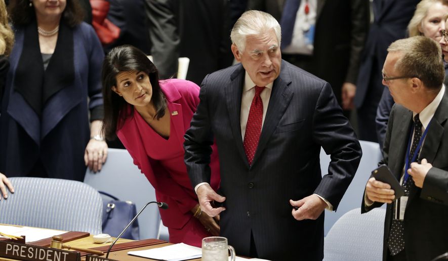 U.S. Secretary of State Rex Tillerson, center, accompanied by U.S. Ambassador Nikki Haley, left, arrives to a ministerial Security Council meeting at United Nations headquarters, Friday, April 28, 2017. (AP Photo/Richard Drew)