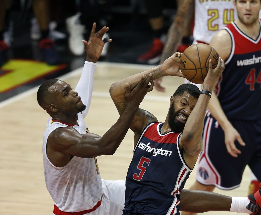 Washington Wizards forward Markieff Morris (5) battles Atlanta Hawks guard Tim Hardaway Jr. (10) for a rebound in the second half of Game 6 of a first-round NBA playoff basketball series Friday, April 28, 2017, in Atlanta. (AP Photo/John Bazemore)