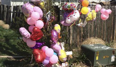 FILE - In This April 22, 2016 file photo a memorial is placed in front of the house for Kenzley Olson in Poplar, Mont. Federal prosecutors say Janelle Red Dog of Poplar, abused Olson, a 13-month-old girl in her care, and used methamphetamine while Olson was unconscious and, when she stopped breathing, put her body in a bag and threw it in a trash can before going home to sleep. Red Dog is scheduled to plead guilty on May 1, 2017 to second-degree murder. (AP Photo/Richard Peterson, File)