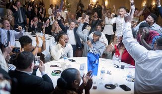 The room erupts around Malik Hooker, center left, still on the phone with the Indianapolis Colts, as it is announced on television that he had been selected by the Colts with the 15th pick in the first round of the NFL football draft, Thursday, April 27, 2017 in New Castle, Pa. (Haley Nelson/Pittsburgh Post-Gazette via AP)