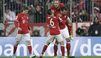 Bayern&#39;s Mats Hummels, right, celebrates with team mates Franck Ribery, top, and Thiago after scoring his side&#39;s second goal during the German Soccer Cup semifinal match between FC Bayern Munich and Borussia Dortmund at the Allianz Arena stadium in Munich, Germany, Wednesday, April 26, 2017. (AP Photo/Matthias Schrader)