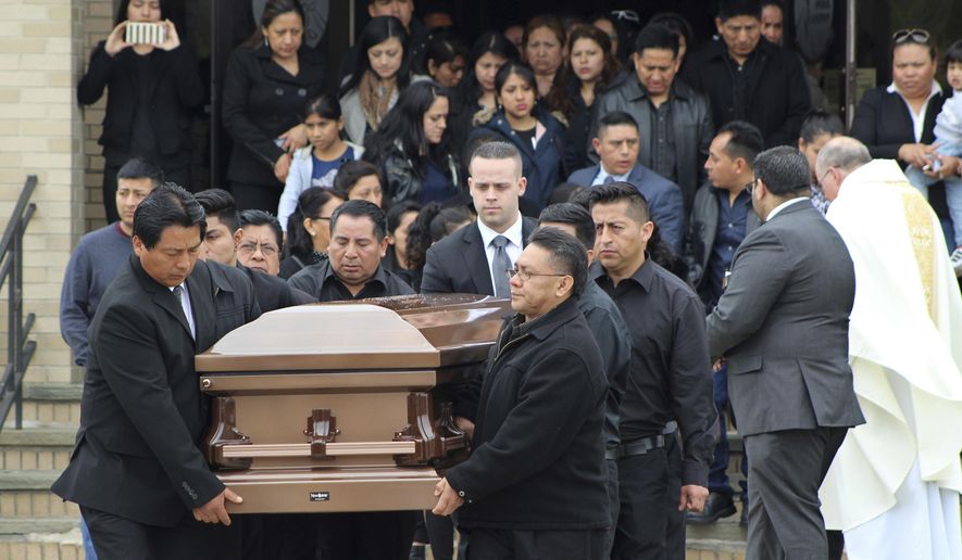 FILE - In this April 19, 2017 file photo, the casket of Justin Llivicura is carried from St. Joseph the Worker Church after Llivicura's funeral in East Patchogue, N.Y. Llivicura, 16, was one of four young men found slain in a suspected MS-13 gang killing in a park in Central Islip, N.Y., on April 12. The gang has been blamed for the deaths of nearly a dozen young people in blue-collar Brentwood and Central Islip since the school year began. (AP Photo/Frank Eltman, File)