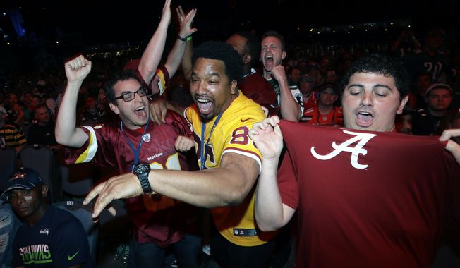 Washington Redskins&#x27; fans react after the team selected Alabama&#x27;s Jonathan Allen during the first round of the 2017 NFL football draft, Thursday, April 27, 2017, in Philadelphia. (AP Photo/Julio Cortez)