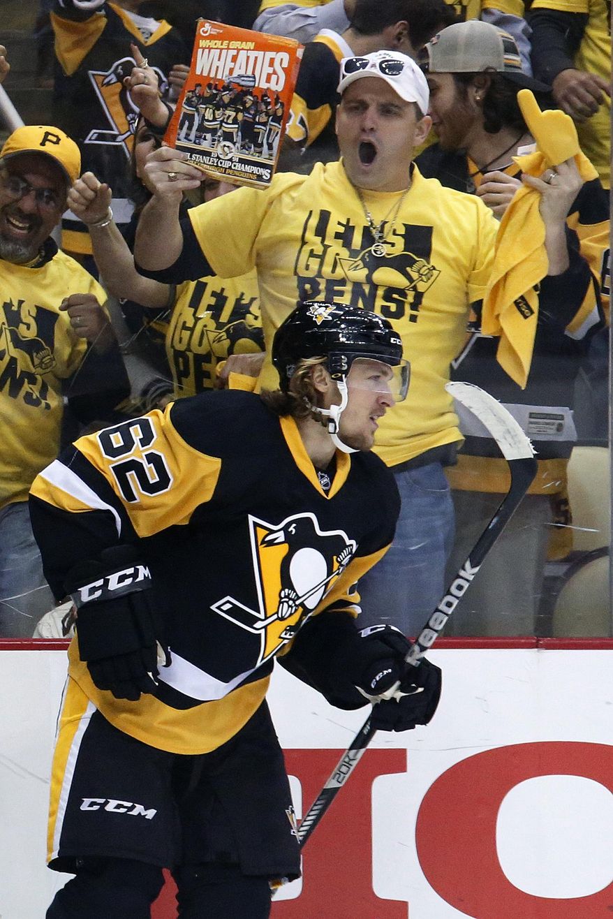 FILE - In this May 10, 2016, file photo, Pittsburgh Penguins' Carl Hagelin, returns to the bench after scoring a goal during Game 6 of the NHL hockey Stanley Cup Eastern Conference semifinals, against the Washington Capitals, in Pittsburgh. Hagelin will be a game-time decision to return to the Penguins’ lineup for Game 2 against the Washington Capitals on Saturday night, April 29, 2017. Coach Mike Sullivan says Hagelin has progressed far enough in his recovery from a lower-body injury to be an option to play for the first time since March 10. (AP Photo/Gene J. Puskar, File)