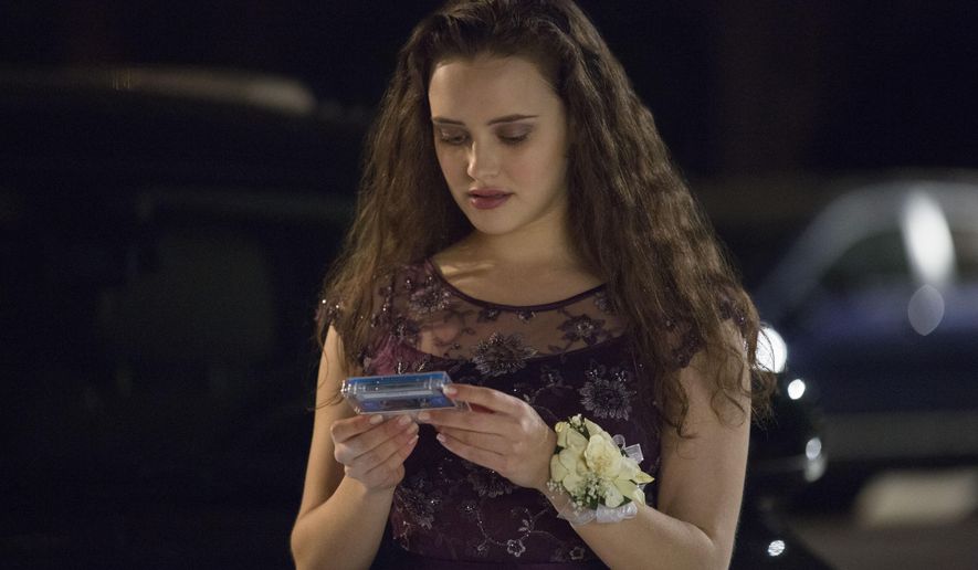 This image released by Netflix shows Katherine Langford in a scene from the series, &amp;quot;13 Reasons Why,&amp;quot; about a teenager who commits suicide. The stomach-turning suicide scene has triggered criticism from some mental health advocates that it romanticizes suicide and even promoted many schools across the country to send warning letters to parents and guardians. The show’s creators are unapologetic, saying their frank depiction of teen life needs to be “unflinching and raw.” (Beth Dubber/Netflix via AP)
