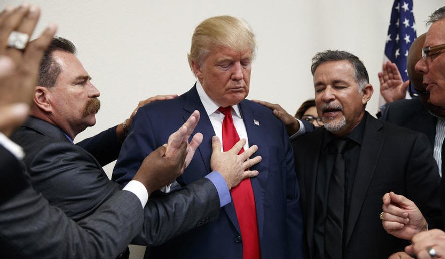 Pastors from the Las Vegas area pray with Republican presidential candidate Donald Trump during a visit to the International Church of Las Vegas, and International Christian Academy on Oct. 5, 2016, in Las Vegas, Nev. (Photo by Evan Vucci/AP)