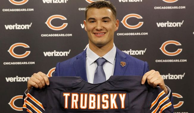 Chicago Bears&#x27; first round draft pick quarterback Mitchell Trubisky, from North Carolina, poses with a Bears&#x27; jersey during an NFL football news conference Friday, April 28, 2017, in Lake Forest , Ill. (AP Photo/Charles Rex Arbogast)