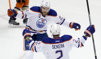 Edmonton Oilers defenseman Andrej Sekera celebrates his goal with center Leon Draisaitl, top, during the first period in Game 2 of a second-round NHL hockey Stanley Cup playoff series against the Anaheim Ducks in Anaheim, Calif., Friday, April 28, 2017. The Oilers won 5-3. (AP Photo/Chris Carlson)