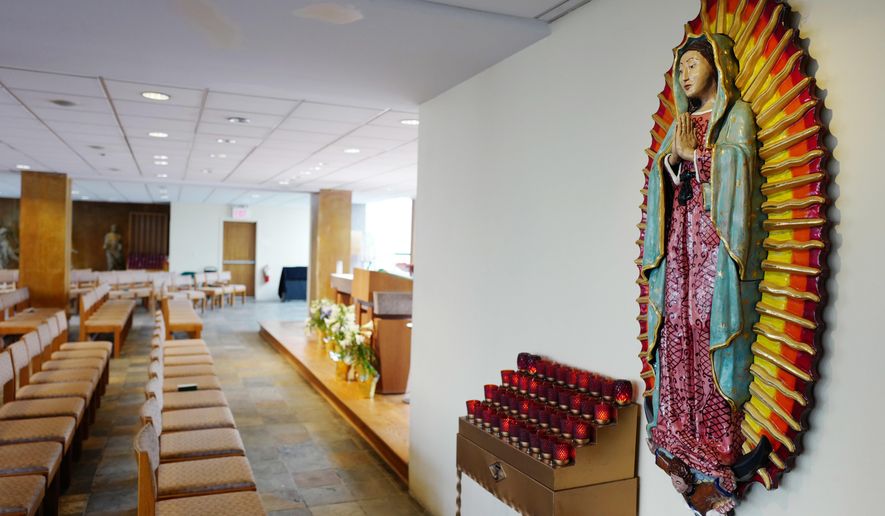 A sculpture of Our Lady of Guadalupe adorns St. Joseph's Chapel, Thursday, April 27, 2017, in New York. The Roman Catholic chapel that sheltered first responders after the destruction of the World Trade Center and was reborn as a memorial to the terrorist attack's victims may fall victim itself to the prosperity of its resurgent New York City neighborhood. (AP Photo/Mark Lennihan)
