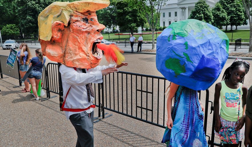 Demonstrators wearing papier-mch heads representing President Donald Trump and the planet Earth, walk along Pennsylvania Ave., in front of the White House in Washington, during a demonstration and march, Saturday, April 29, 2017. Thousands of people gather across the country to march in protest of President Donald Trump&#39;s environmental policies, which have included rolling back restrictions on mining, oil drilling and greenhouse gas emissions at coal-fired power plants. (AP Photo/Pablo Martinez Monsivais)