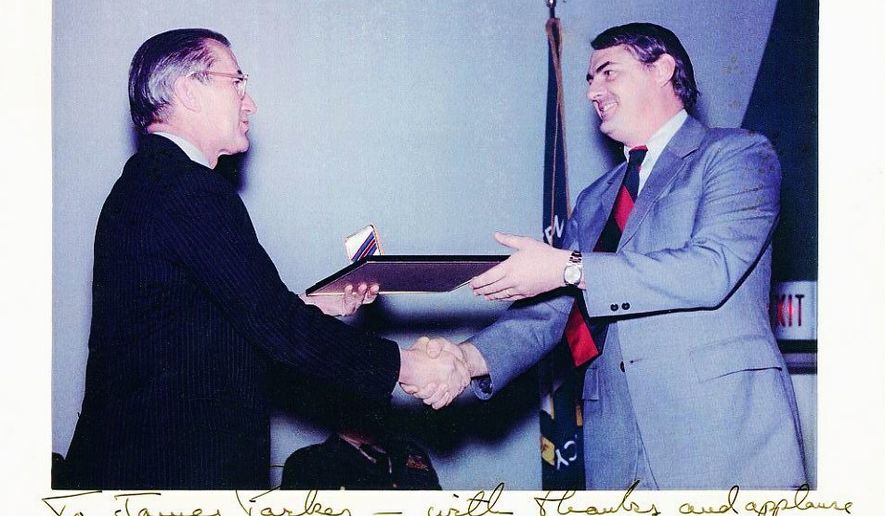 James Parker (right) received the CIA&#39;s Intelligence Medal of Merit from CIA Director William Colby in 1975.  This photograph is signed: &quot;To James Parker — with thanks and applause for a job well done in Vietnam. William Colby, 18 Dec. 75.&quot; (Photograph provided by James Parker)