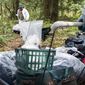 This photo taken Tuesday, April 18, 2017, shows Bellingham Parks and Recreation employees dragging items from a homeless man&#39;s camp on sleds at Whatcom Falls Park  in Bellingham, Wash.  As the city continues to clean up homeless camps in parks and under bridges, Mayor Kelli Linville said a proposed shelter would offer one solution to a growing problem. The city has a backlog of more than 70 camps. Since 2014, the city has removed 427 camps at nearly 300 places around Bellingham. Most of them were in the city’s parks and creek corridors. (Evan Abell /The Bellingham Herald via AP)