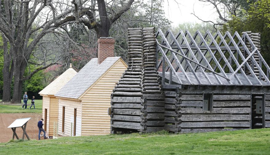 In this Wednesday, April 12, 2017 photo, visitors look over reconstructed slave cabins in the South Yard slave community at James Madison's estate, in Montpelier, Va. The slave quarters were cleared away more than 150 years ago and planted over with grass. The reconstruction began in 2015 after a gift from David Rubenstein, a Washington philanthropist and history buff. (AP Photo/Steve Helber)'