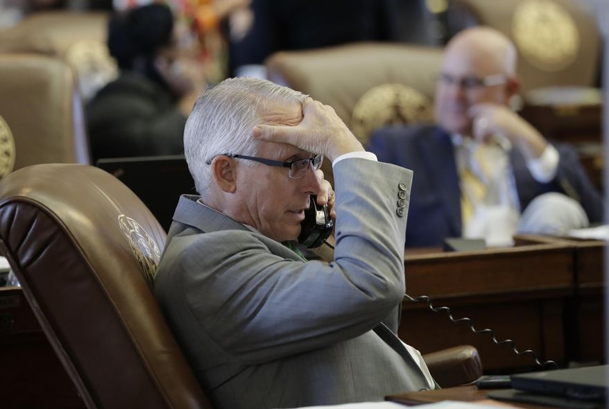 In this Wednesday, April 19, 2017, photo, Rep. Gary VanDeaver, R-New Boston, works at his desk in the House Chamber at the Texas State Capitol, in Austin, Texas. Texas has led the way on many of the country's top conservative issues, from guns and small government to imposing harsh limits on abortion and strict voter ID rules, but offering taxpayer funding to private schools is one issue Texas is actively opposing. “In my district, public school is the community,” said VanDeaver. (AP Photo/Eric Gay)