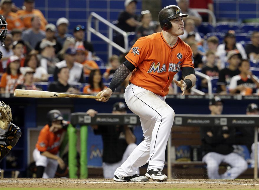 Miami Marlins' Justin Bour watches after hitting an RBI-single to score Dee Gordon and Giancarlo Stanton during the fifth inning of a baseball game against the Pittsburgh Pirates, Sunday, April 30, 2017, in Miami. (AP Photo/Lynne Sladky)